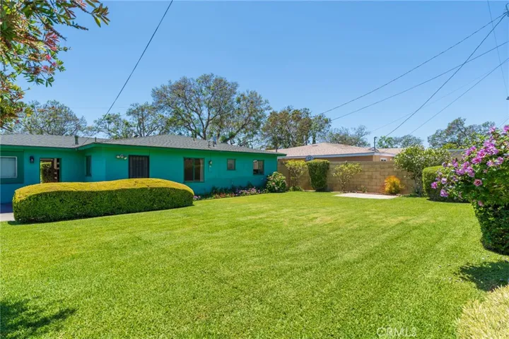 Huge back yard with block walls around the side and back.