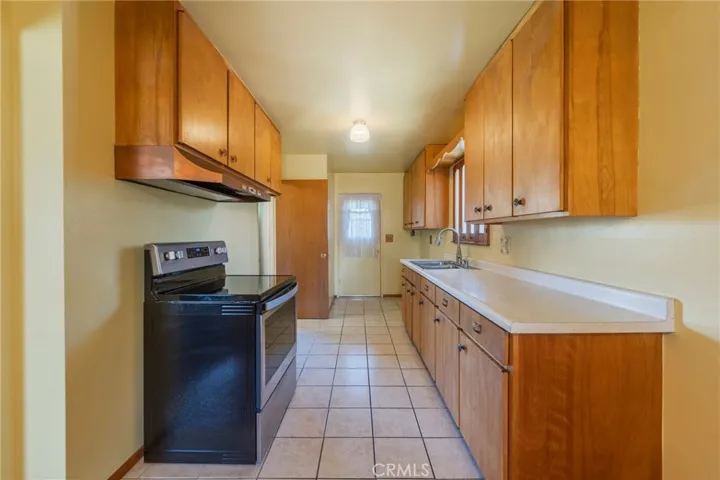 Galley kitchen has door to the back yard.