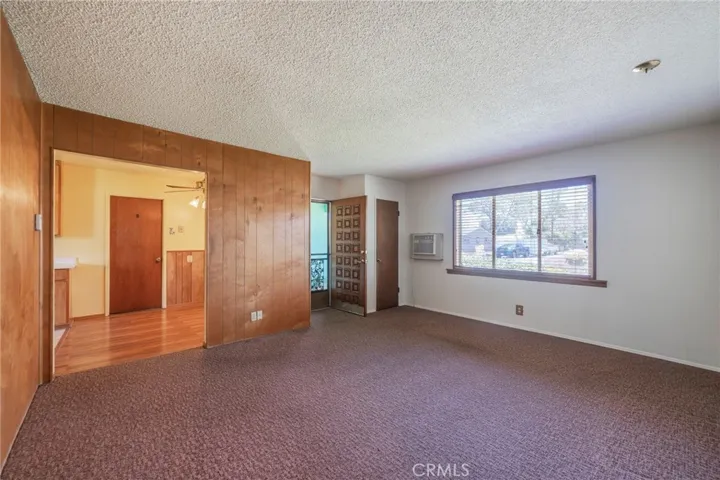 Wall paneling in living room with access to the dining area & kitchen.