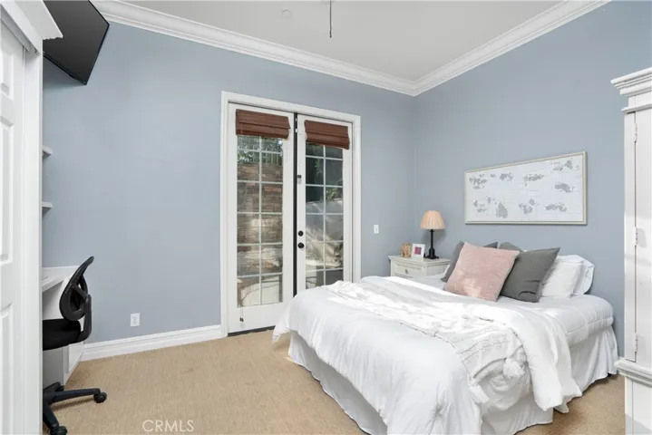 Downstairs bedroom #1 with french doors leading to the backyard.