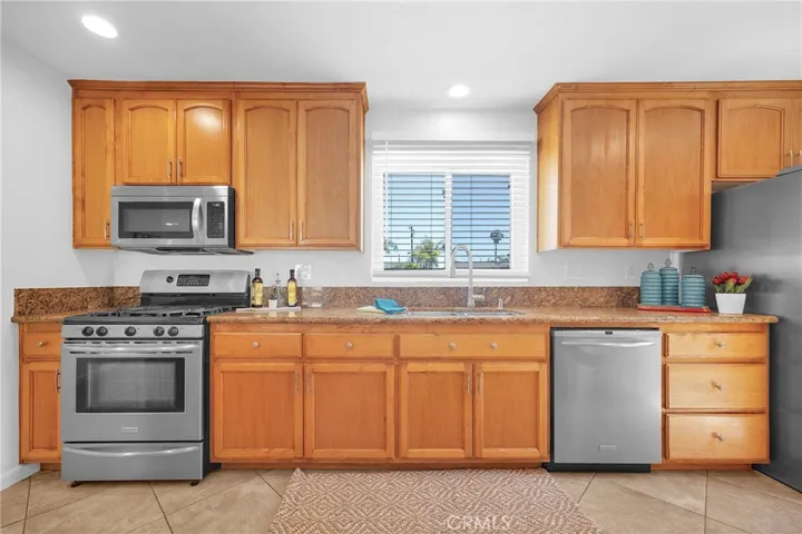roomy kitchen with sunny view! The stainless steel appliances are staying: Ranger, Refrigerator, Dishwasher, Microwave, Washer/Dryer