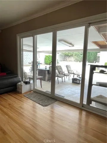 Large sliding glass doors in living room open up onto covered patio