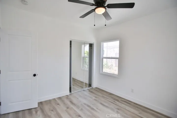 2nd bedroom with new flooring and lighting