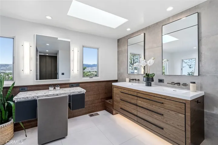 The Vanity mirror on the left features a television built into the mirror. Note, motion sensor lighting under cabinetry.
