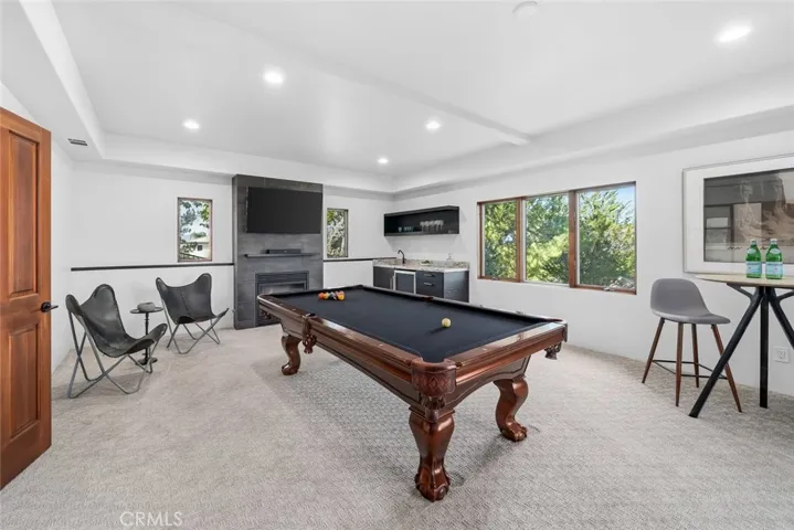 The Game Room, features a wet bar, beverage refrigerator and fireplace.