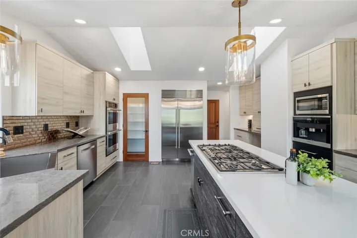 Dream Kitchen, with Custom cabinets, Quartzite Counters. Down draft gas cooktop, double ovens, built-in Miele Coffee machine.  
