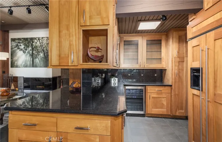 WEALTH OF KITCHEN CABINETS, BUILT IN REFRIGERATOR.  THERE IS A WALK IN PANTRY