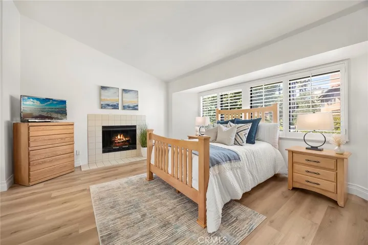 Primary Bedroom with Fireplace and Large Windows.