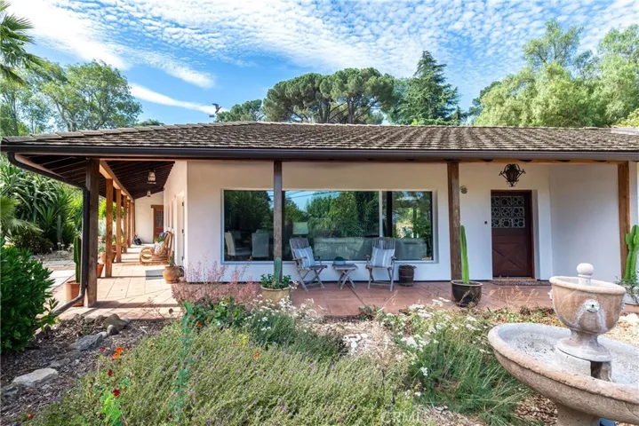 Hacienda style wrap-around porch reminiscent of Montecito