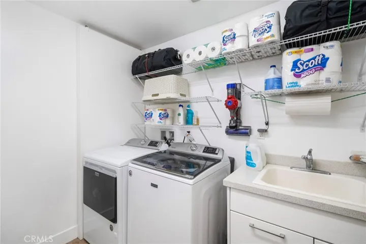 Laundry/utility room with half bath adjacent to it on the lower level.