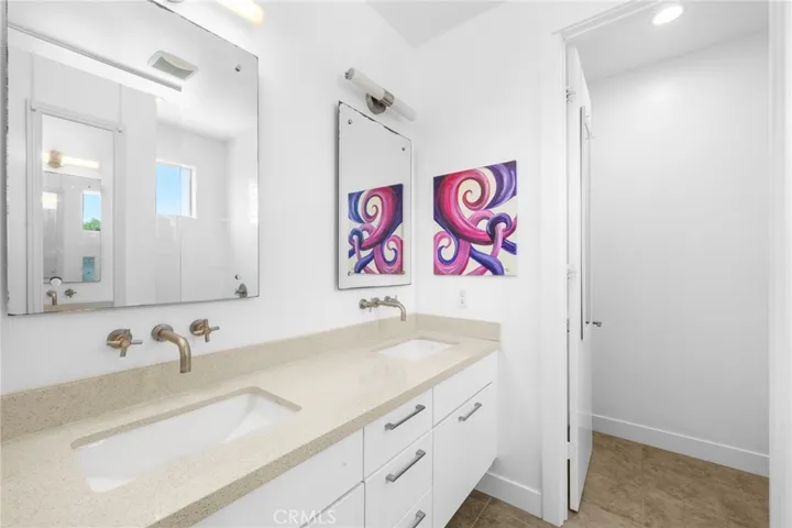 Primary suite bathroom with dual vanity