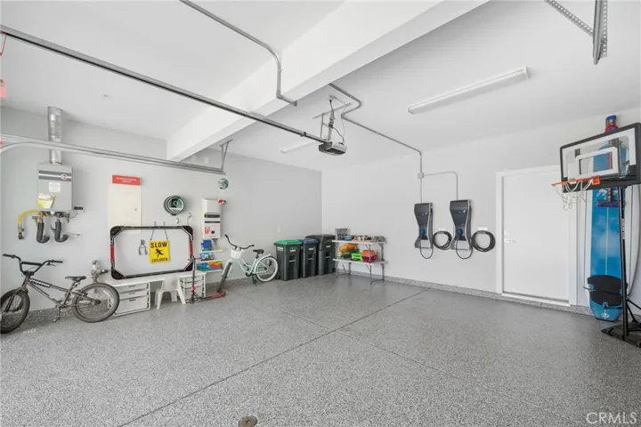 Spacious and finished 2-car garage with 2 EV chargers and FlowWall for storage and organization