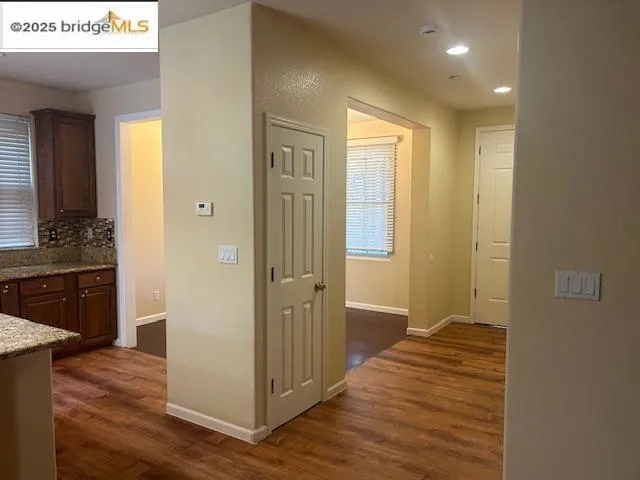 Corridor featuring dark wood-style flooring and recessed lighting