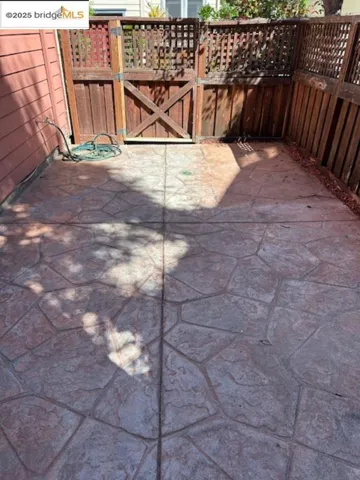 View of patio featuring a gate