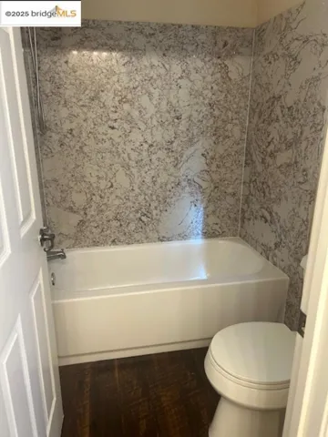 Full bathroom with toilet and bathtub / shower combination