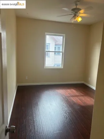 Spare room featuring hardwood / wood-style flooring and ceiling fan