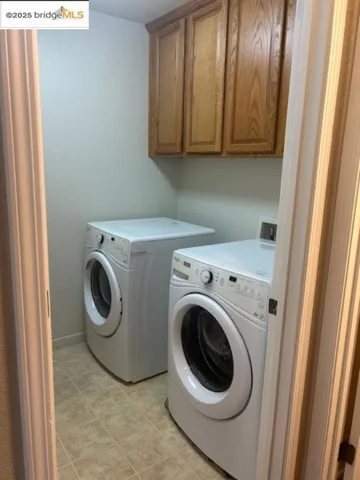 Laundry room with washer and dryer and cabinet space