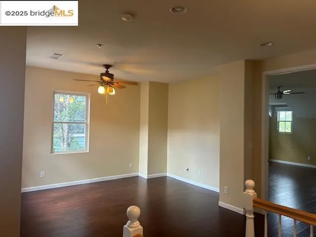 Unfurnished room with a ceiling fan, dark wood-type flooring, and recessed lighting