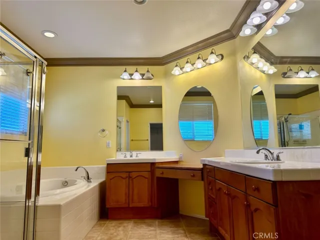 Spacious Master Suite with Dual Vanities, Shower, Tub, and a large Walk-in Closet