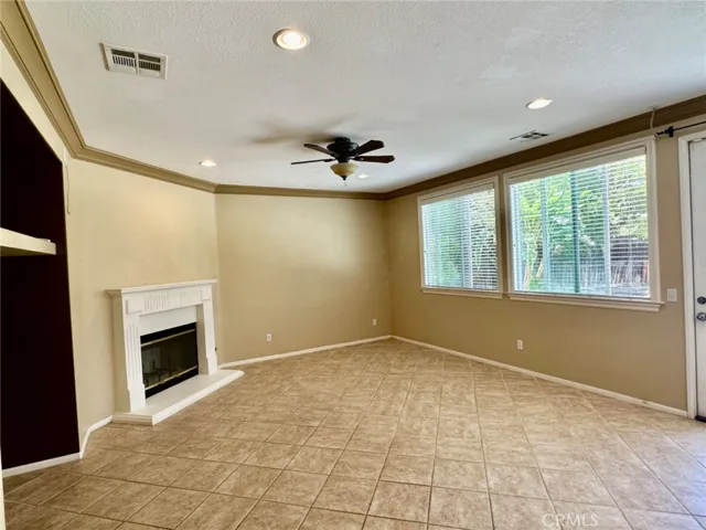  
Family Room opens to the kitchen with Cozy Fireplace, ceiling fan & wired Surround Sound System