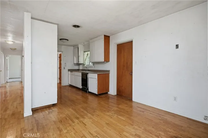 Kitchen with breakfast nook; door on right leads to garage; hallway on left leads to bedrooms