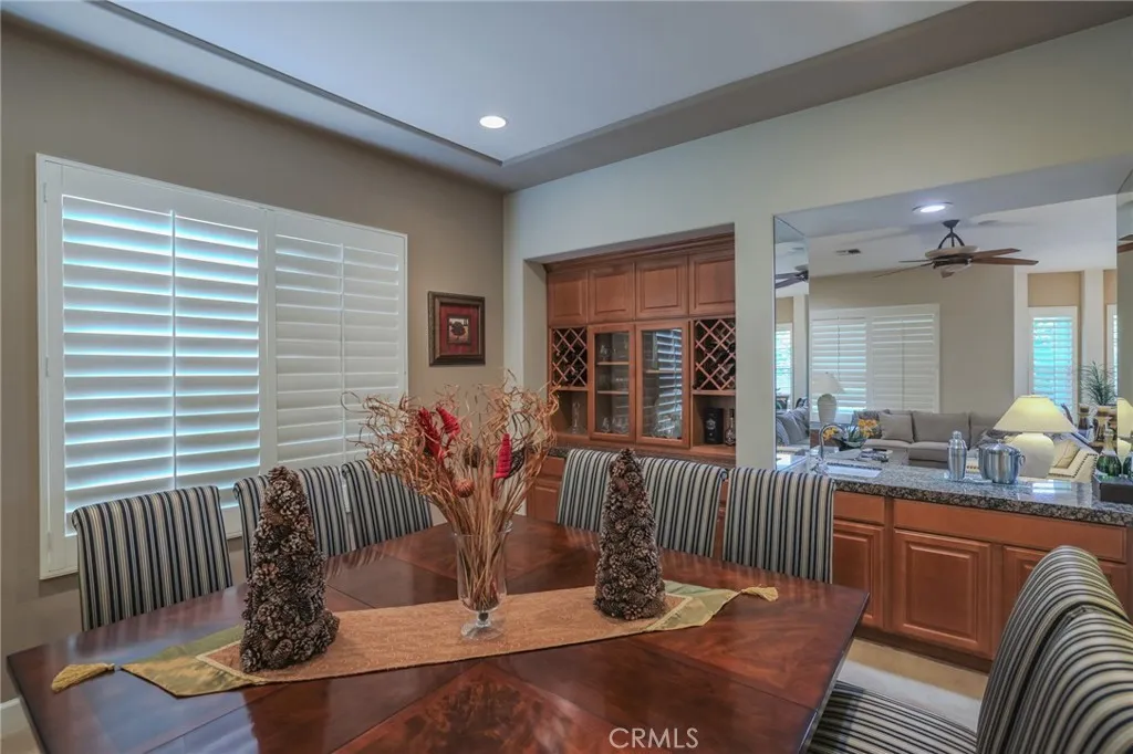 Formal dining room looking at the bar between dining room and family room