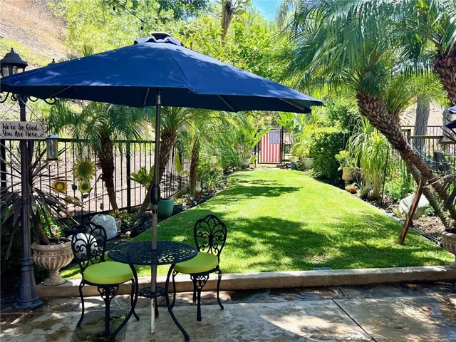 Pravite yard with lawn.  Additional large yard and wildlife area behind gate.