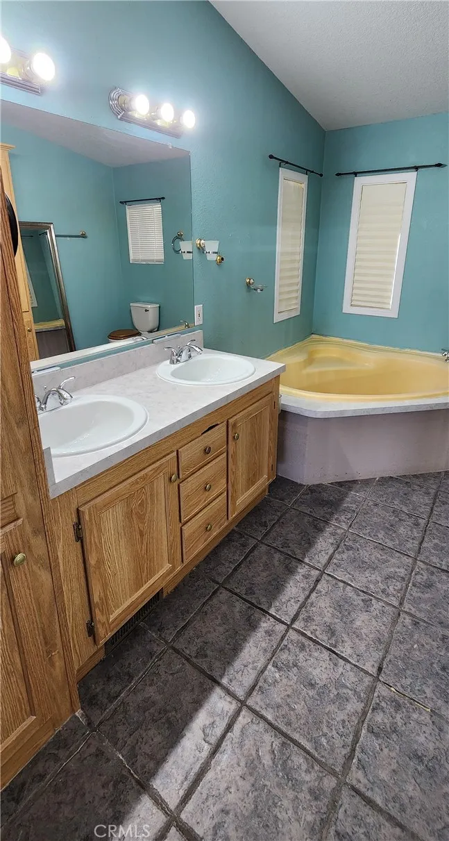 Main house master bathroom with double sinks and soaking tub