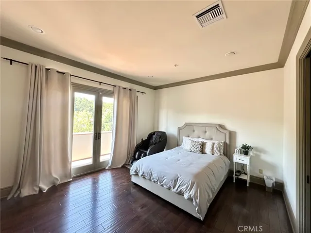 Very spacious primary bedroom with double door access to lanai/patio