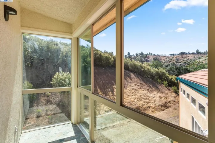 Upstairs bedroom, glassed balcony, two openable windows with screens