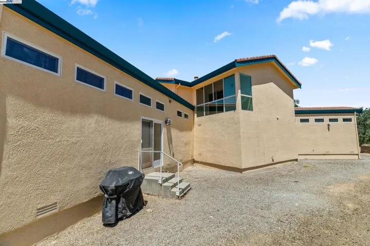 Outside, back of house, large outdoor space and balcony above