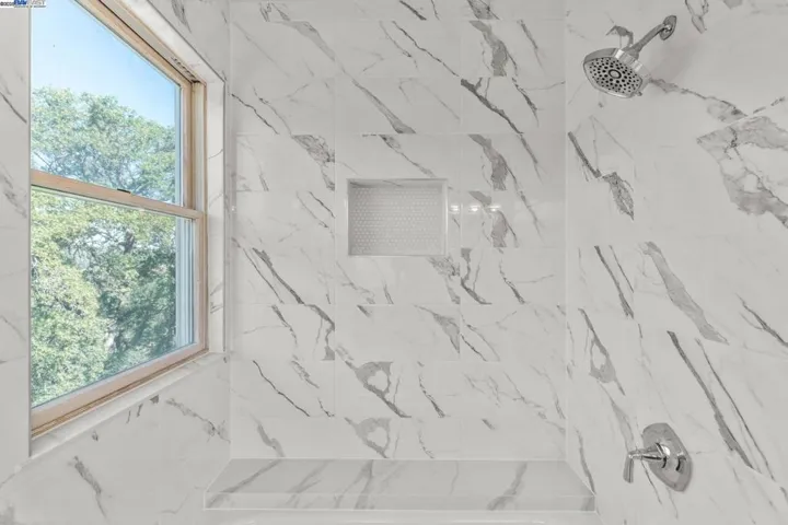 Upstairs bathroom, shower/tub combination, window and tile