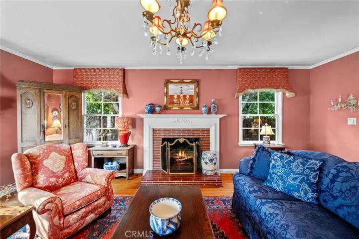 A traditional fireplace anchors the room.