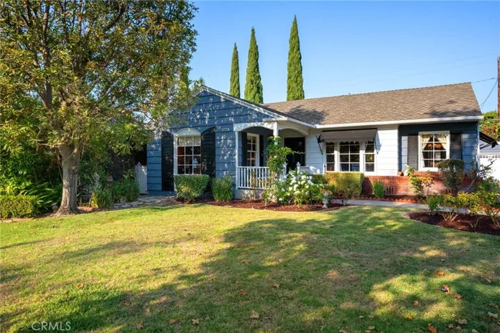 Shingle style with brick, awnings & shutters.