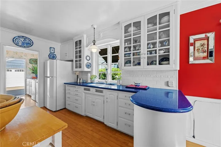 Curvy cabinets with glass uppers.