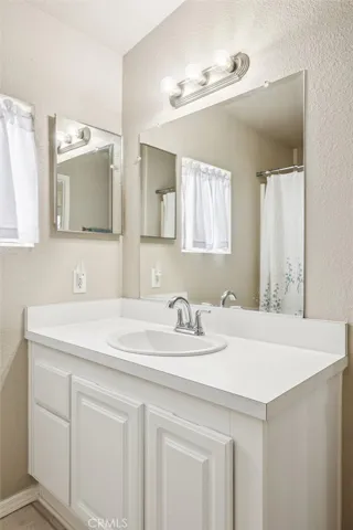 Vanity with mirror and nice lighting.