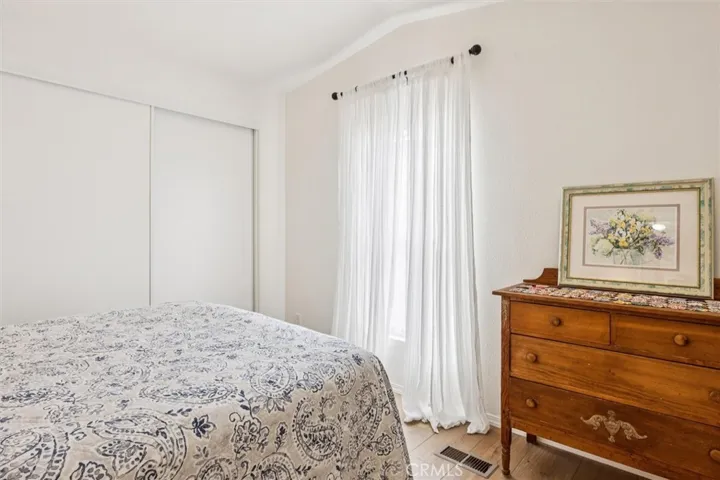 Primary bedroom with sliding closet doors.