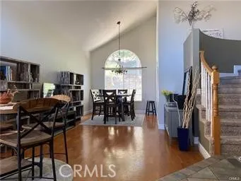 Spacious living room/ dining room combo with vaulted ceilings