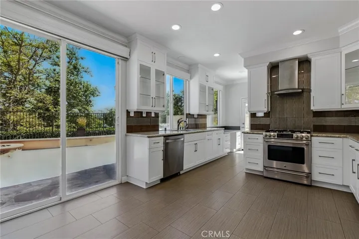 his chef's kitchen is filled with natural light.There are 2 large windows, the patio door and a side door.