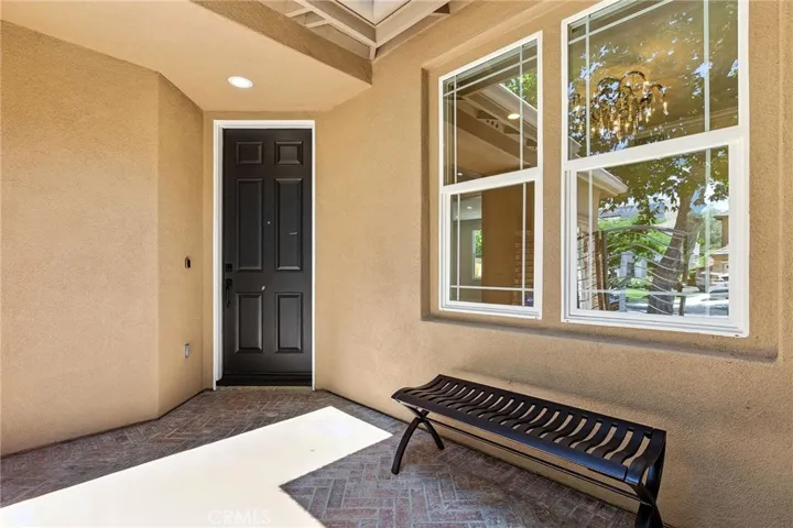 A Polished entry courtyard with lighting and soothing fountain and seating area.