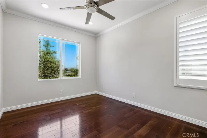Another bedroom with shutters and fan.