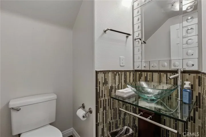Brand new Pedestal glass sink and glass accent tiles makes this the perfect guest bath.