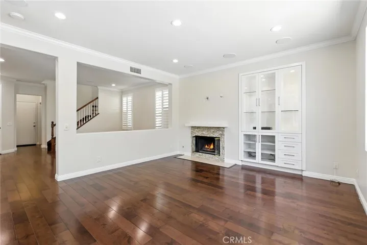 Cozy fireplace with that extra sparkle from the glass rocks. Custom built in cabinets with ceiling audio speakers in both family room, living room and outside.