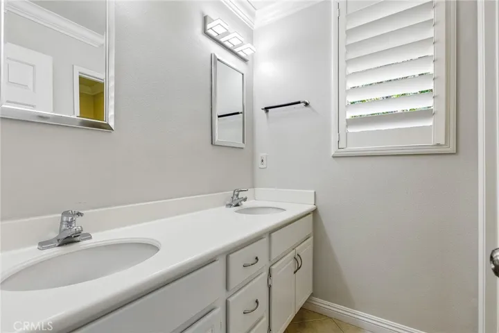 Upstairs bathroom  with dual sinks.