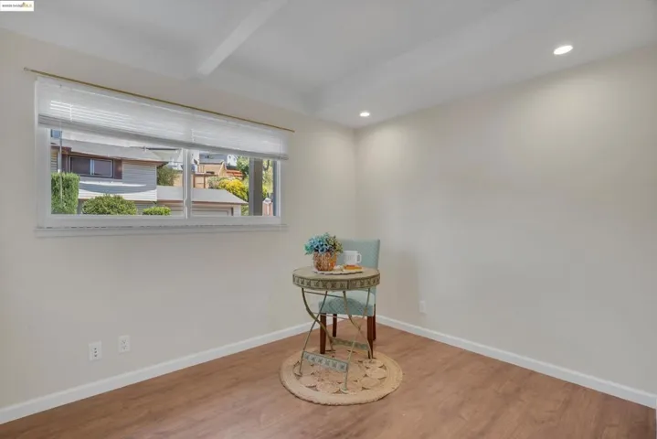 Dining space with wood finished floors, recessed lighting, and beamed ceiling