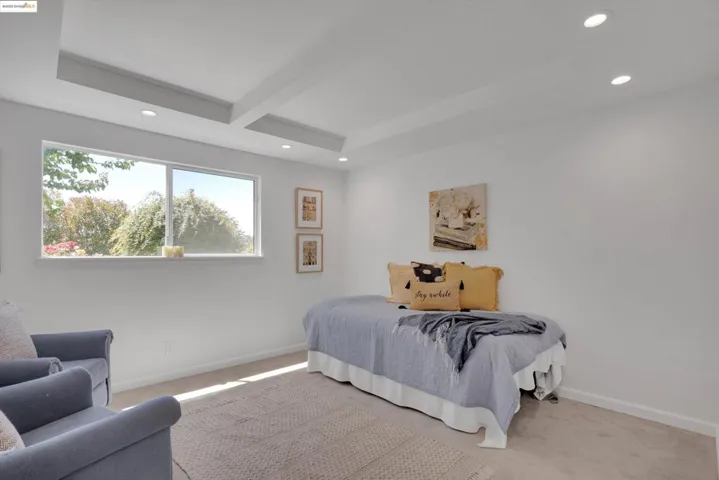 Bedroom featuring recessed lighting, light colored carpet, and beamed ceiling