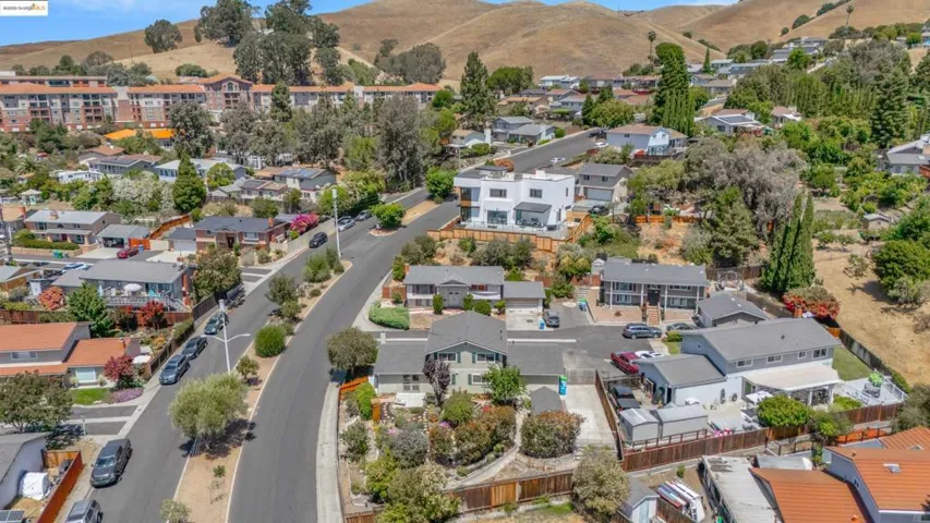 Aerial perspective of suburban area with a mountainous background