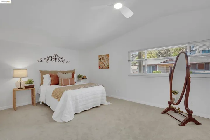 Bedroom featuring lofted ceiling, carpet floors, and a ceiling fan