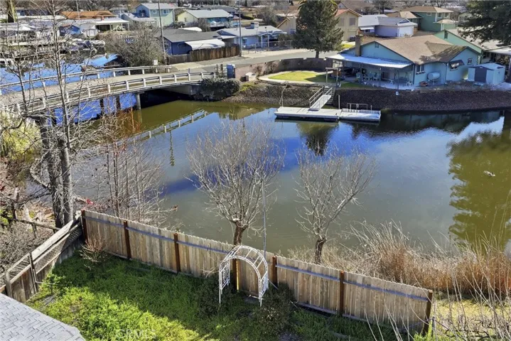 aerial of back yard , fence below is the property with concrete steps to water