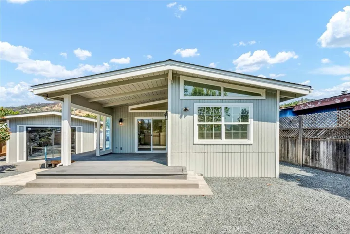 back of home and detached garage with slider door